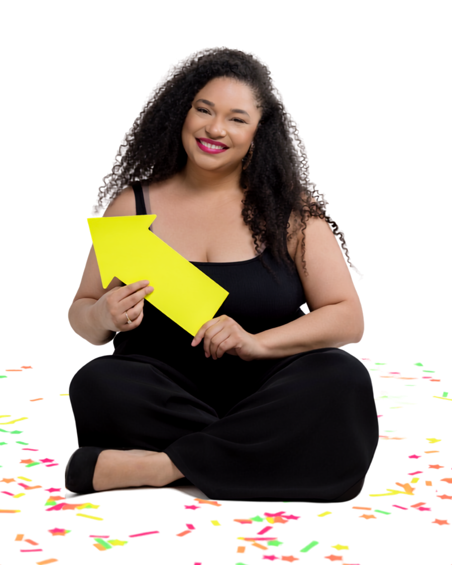 Jillian Thomas sitting on the floor holding a yellow arrow